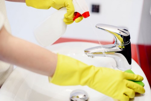 Cleaner applying controlled carpet treatment with safe handling practices