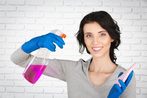 Professional cleaners maintaining desks and shared office surfaces in W1T